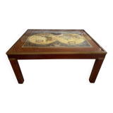 Wood and brass coffee table with a world map under glass.