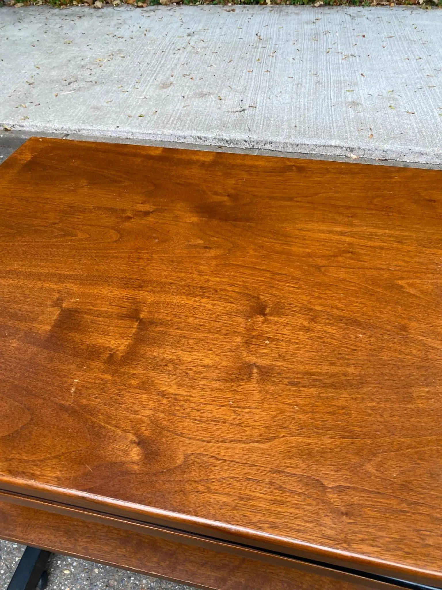 Small Scandinavian-style computer desk on wheels made of wood.