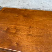 Small Scandinavian-style computer desk on wheels made of wood.