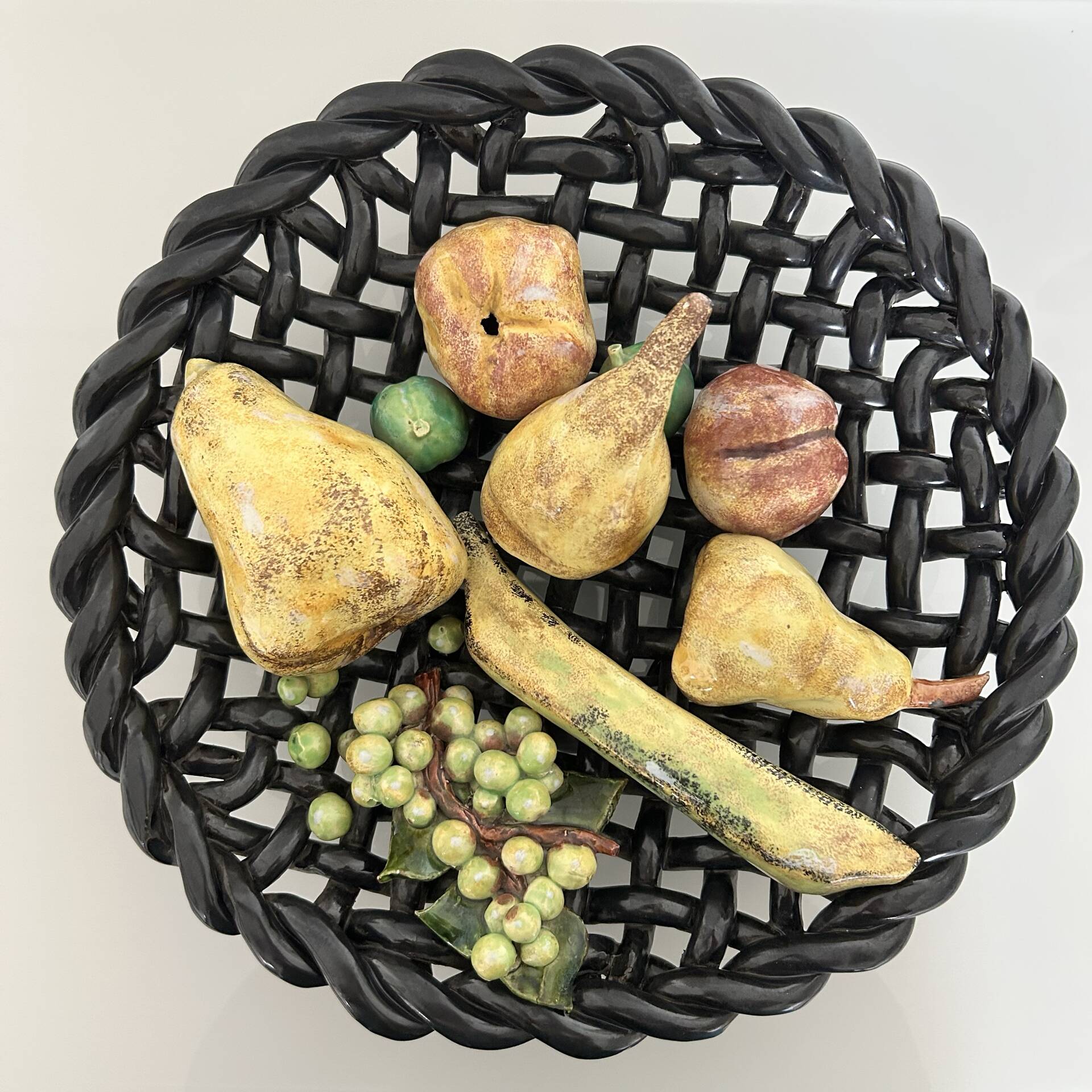 Large woven bowl and trompe l'œil fruits