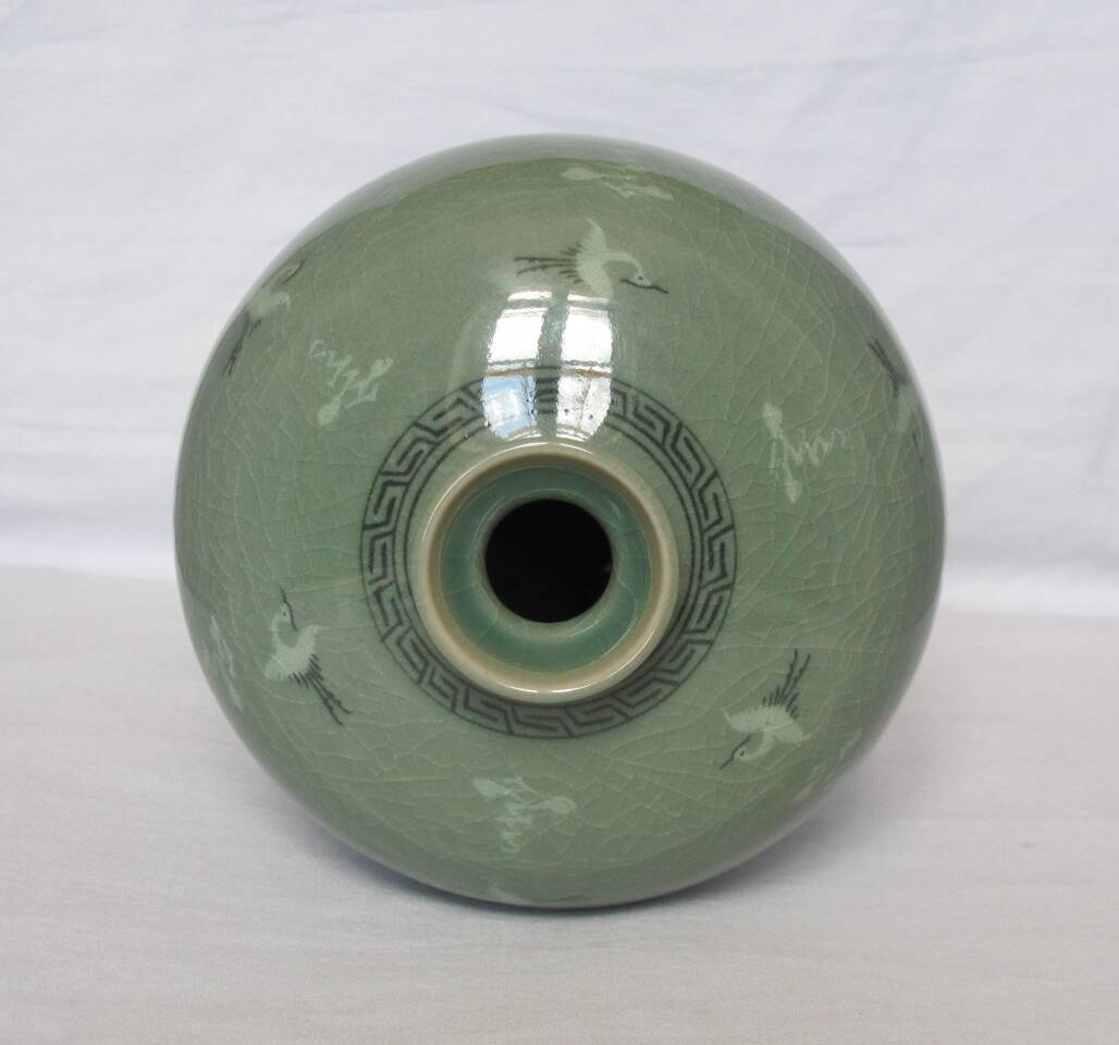 Korean vase in crackled celadon with a pattern of ducks and clouds.