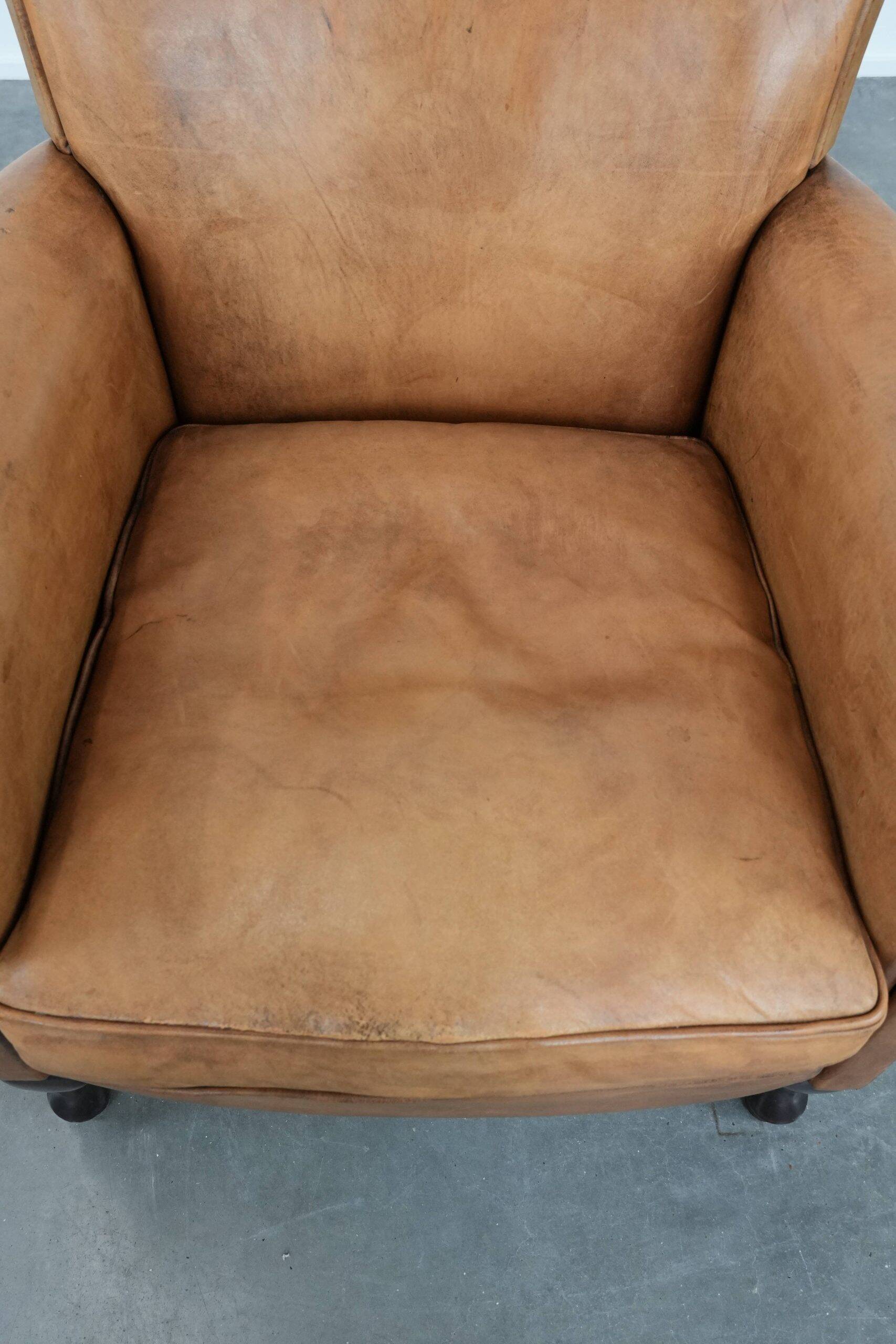 Beautiful subtle vintage sheepskin armchair with elegant legs