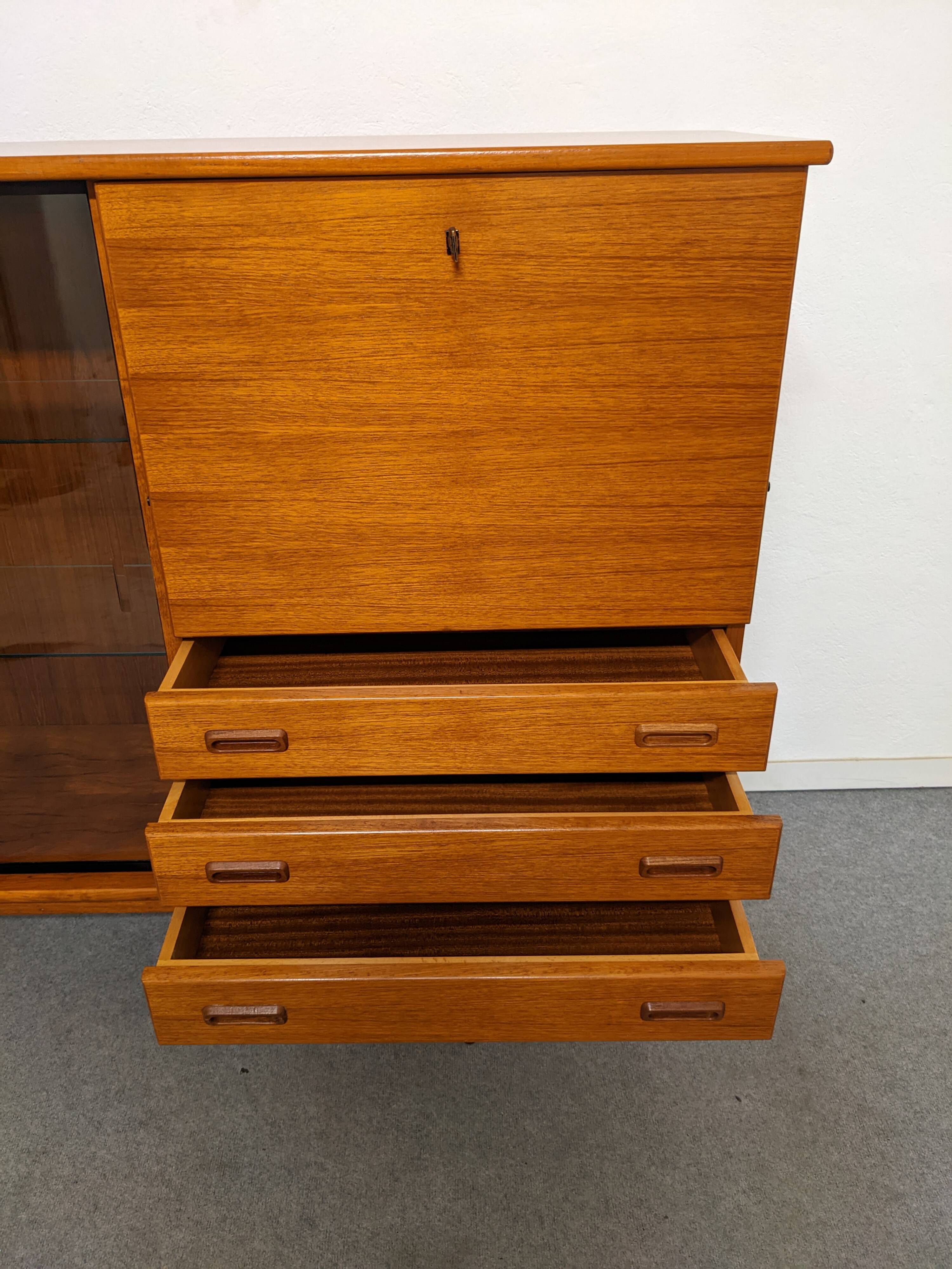 High sideboard, display cabinet and secretary, Scandinavian in teak, France around 1960.