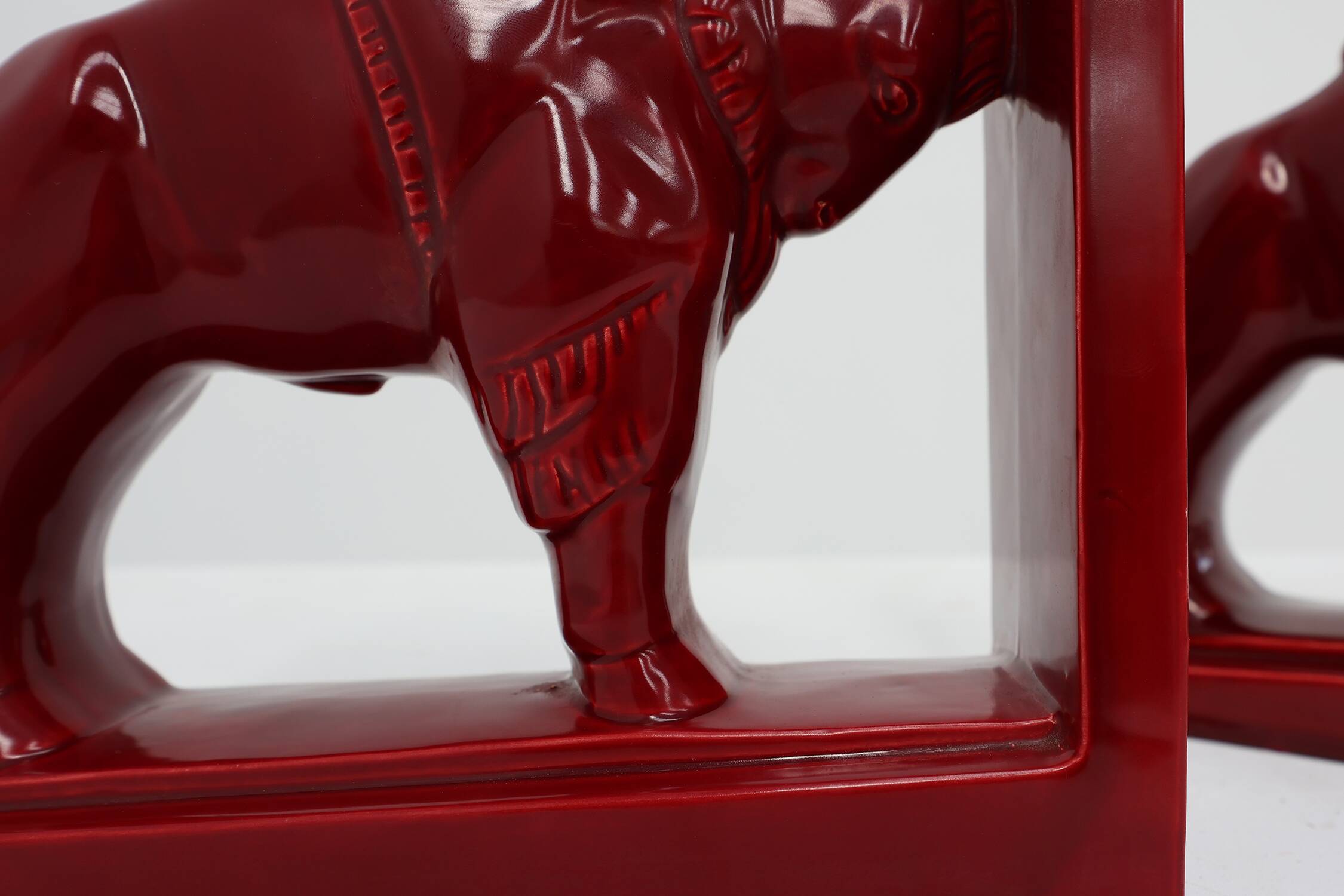 Pair of red glazed ceramic Bison ox bookends in Art Deco style, Belgium