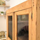 Glass-fronted cabinet in solid wood