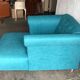Mid-century turquoise blue fabric sofa with solid oak legs and tufting.