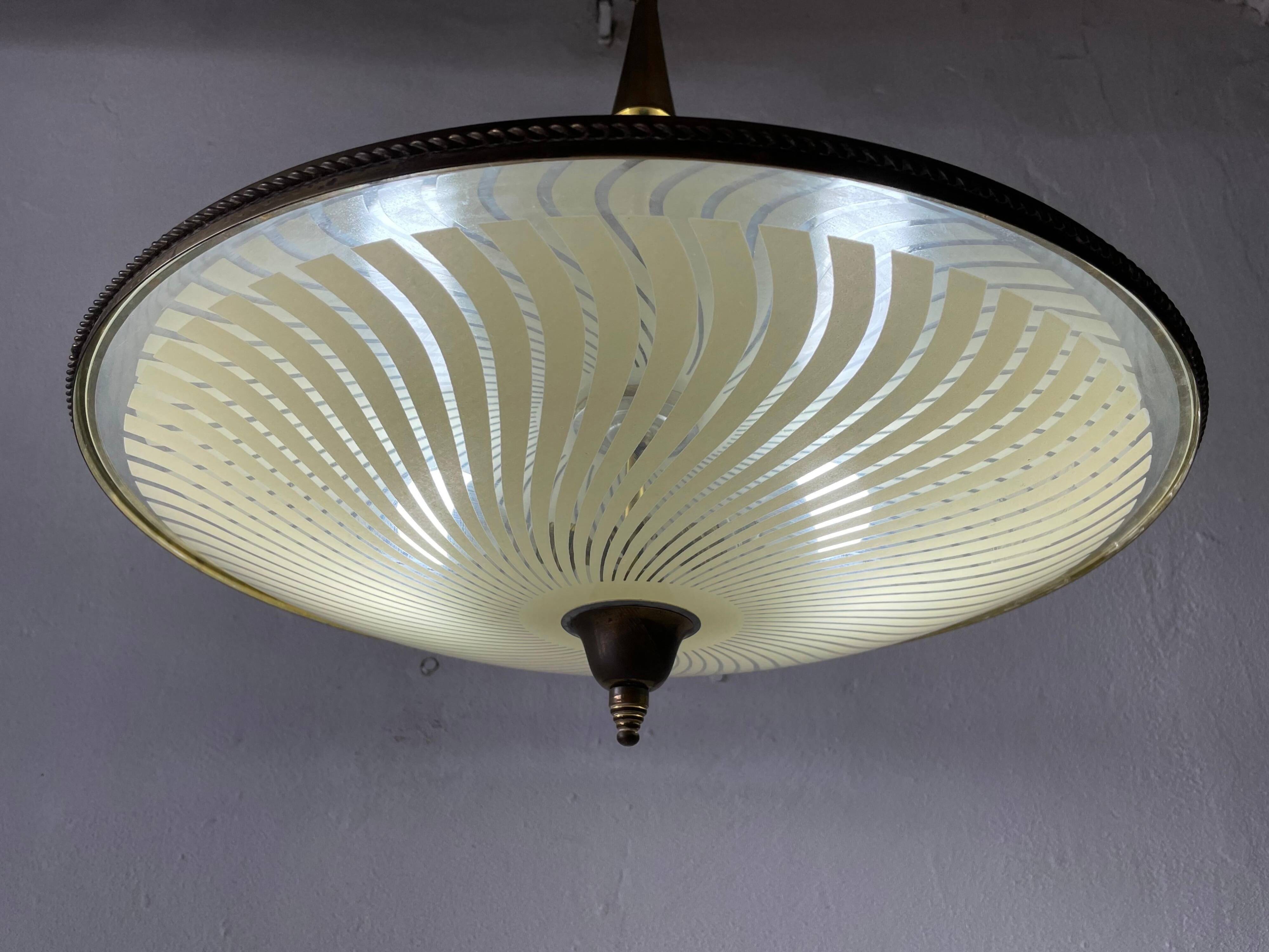 Large UFO design ceiling light in brass and printed glass, 1950s, Italy.