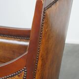 Sheepskin and wooden vintage Art Deco design armchair in a cognac color
