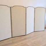 Vintage white faux leather screen with four studded panels, elegant decor.