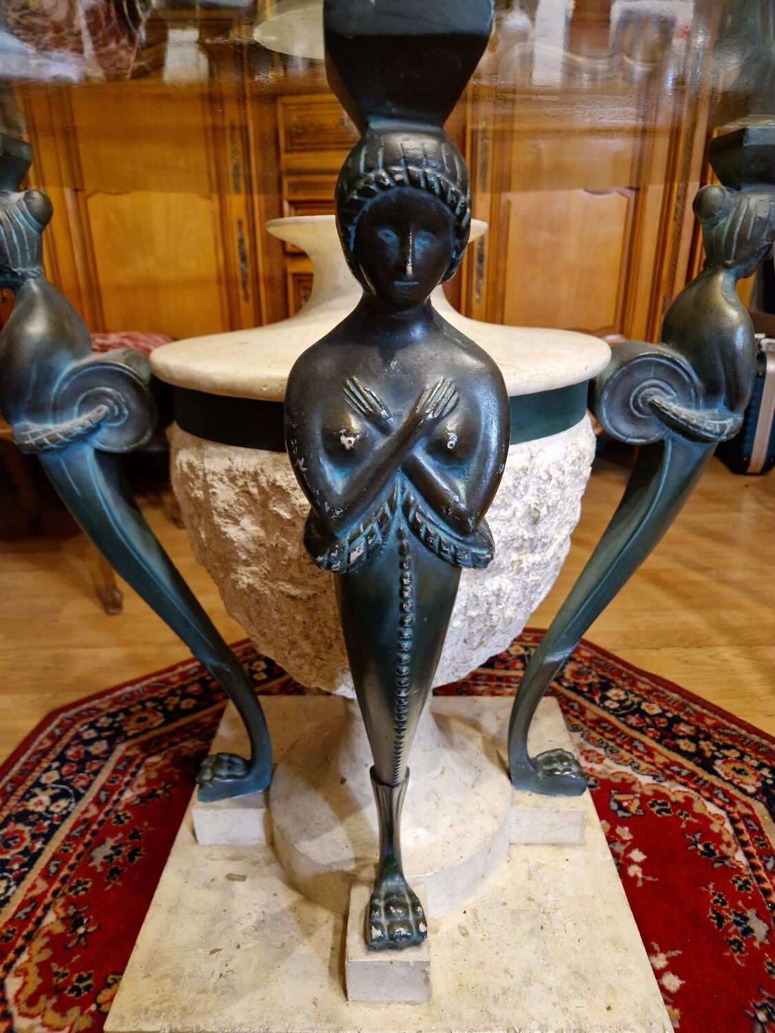 Stone and bronze dining table with ribbed glass top