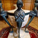 Stone and bronze dining table with ribbed glass top
