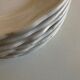 Set of 7 Mougins plates in white enamelled clay with gadroons