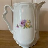 Old ceramic pitcher decorated with flowers