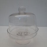 Old bell with cakes on glass stand
