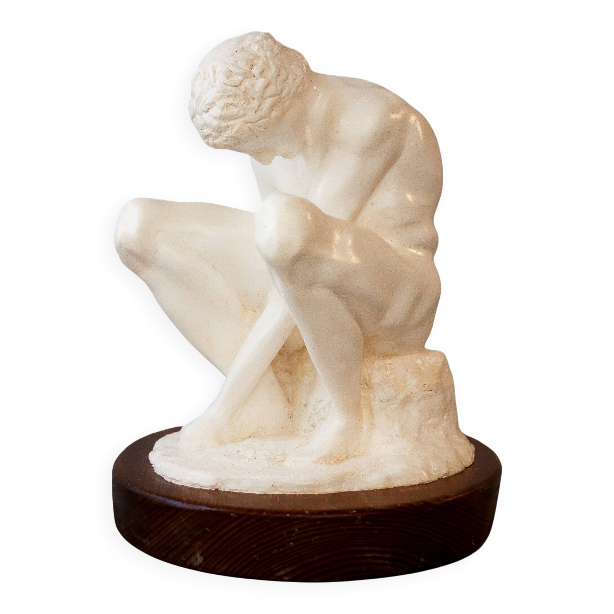 Sculpture of a seated man. Classical male sculpture. Male figure.