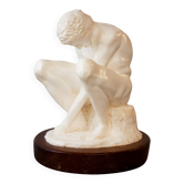 Sculpture of a seated man. Classical male sculpture. Male figure.