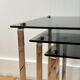 Nest of coffee tables in chrome with smoked glass top.