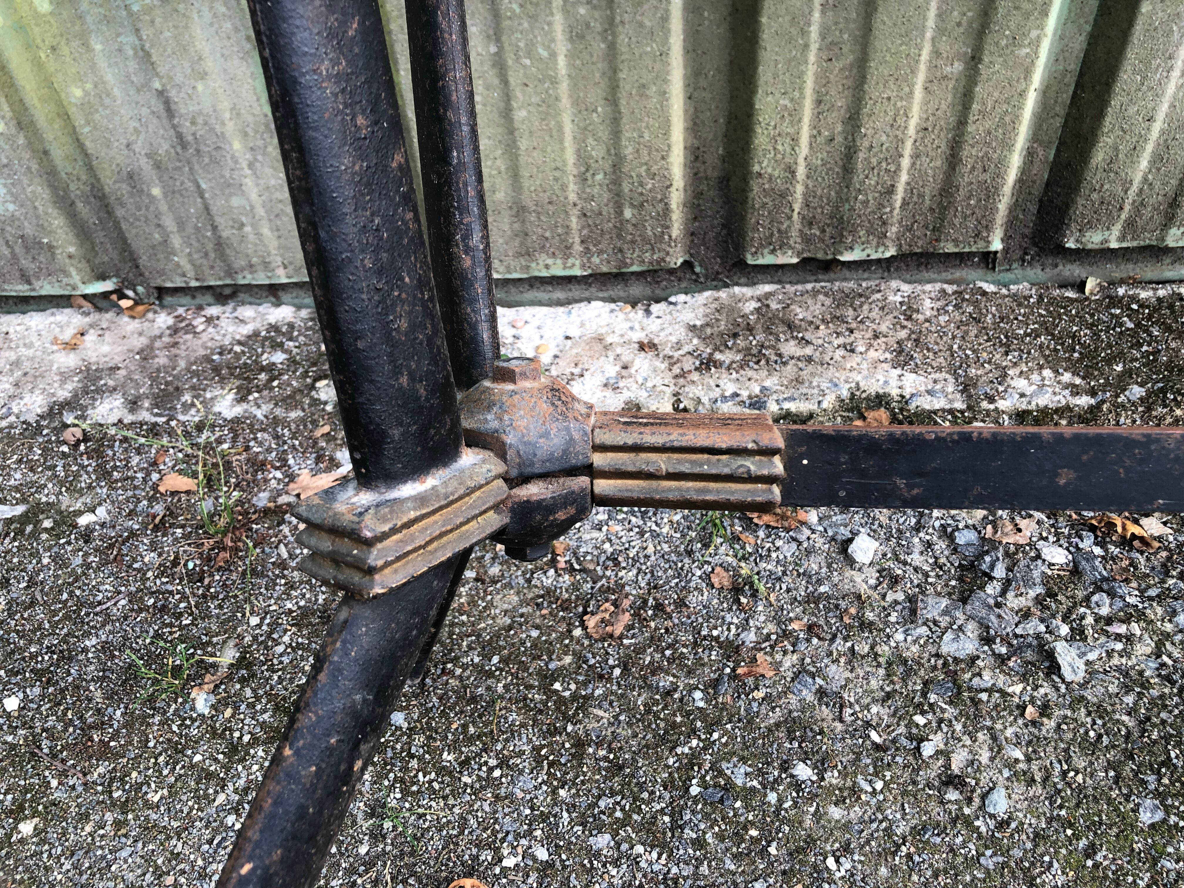 Vintage bistro table with an Art Deco style cast iron base and Formica top.
