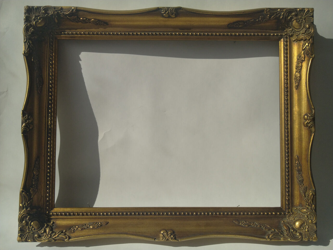 Golden sculpted frame for photo or artwork