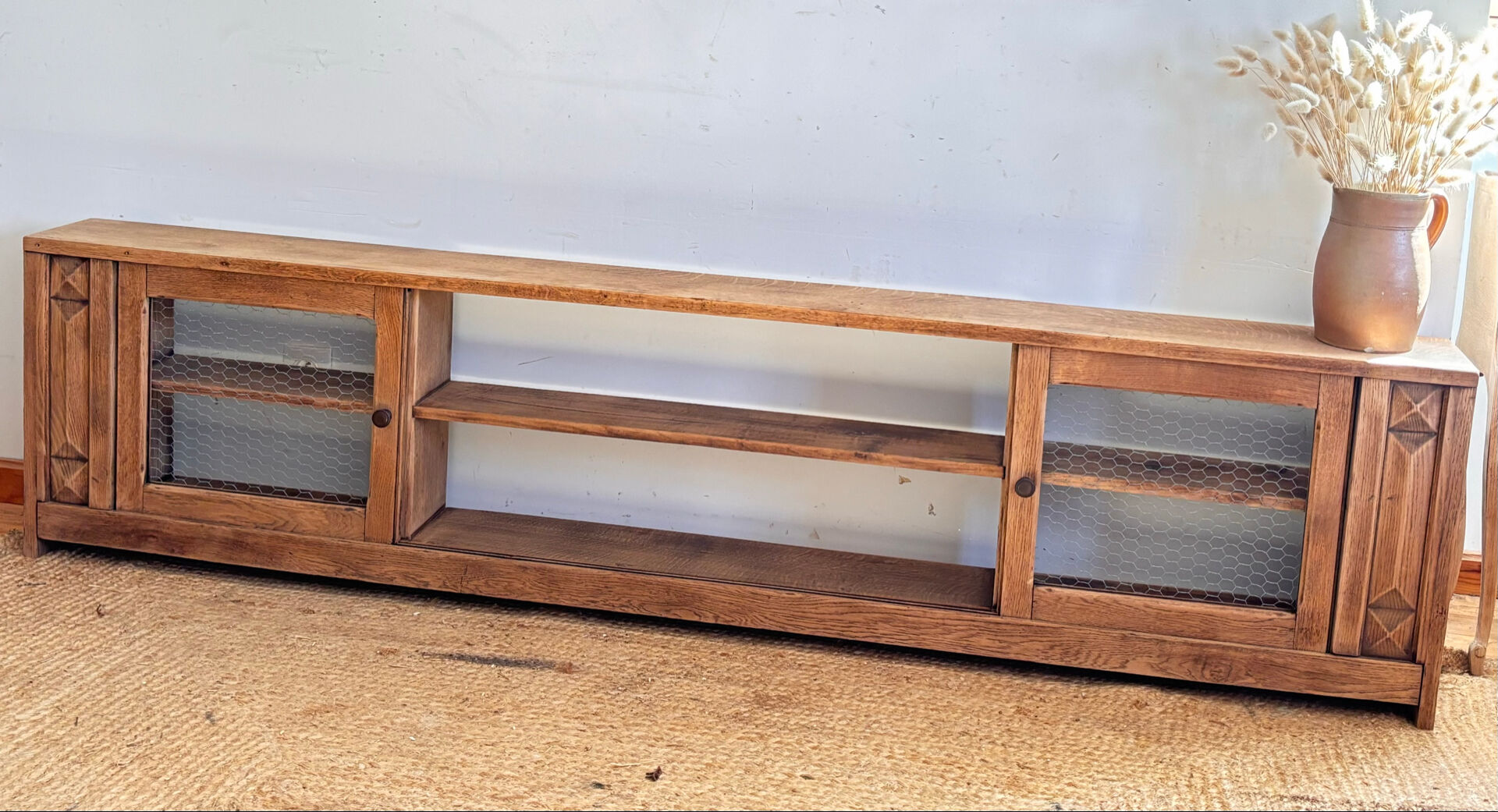 Vintage oak sideboard TV unit with sliding doors.