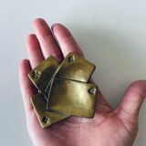 Empty pocket square of aces in brass