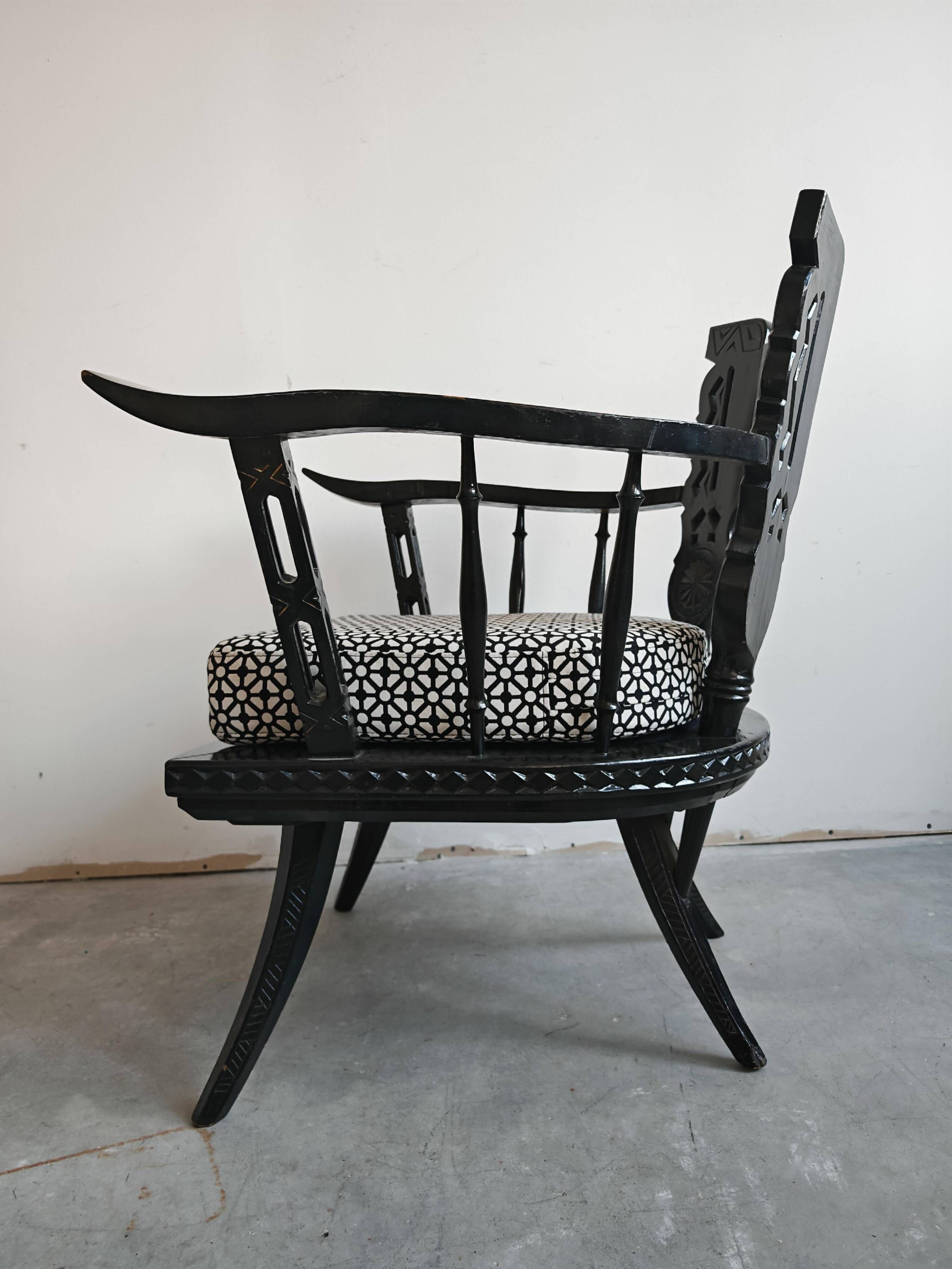 Pair of antique hand-carved armchairs in black lacquer from the 1920s.