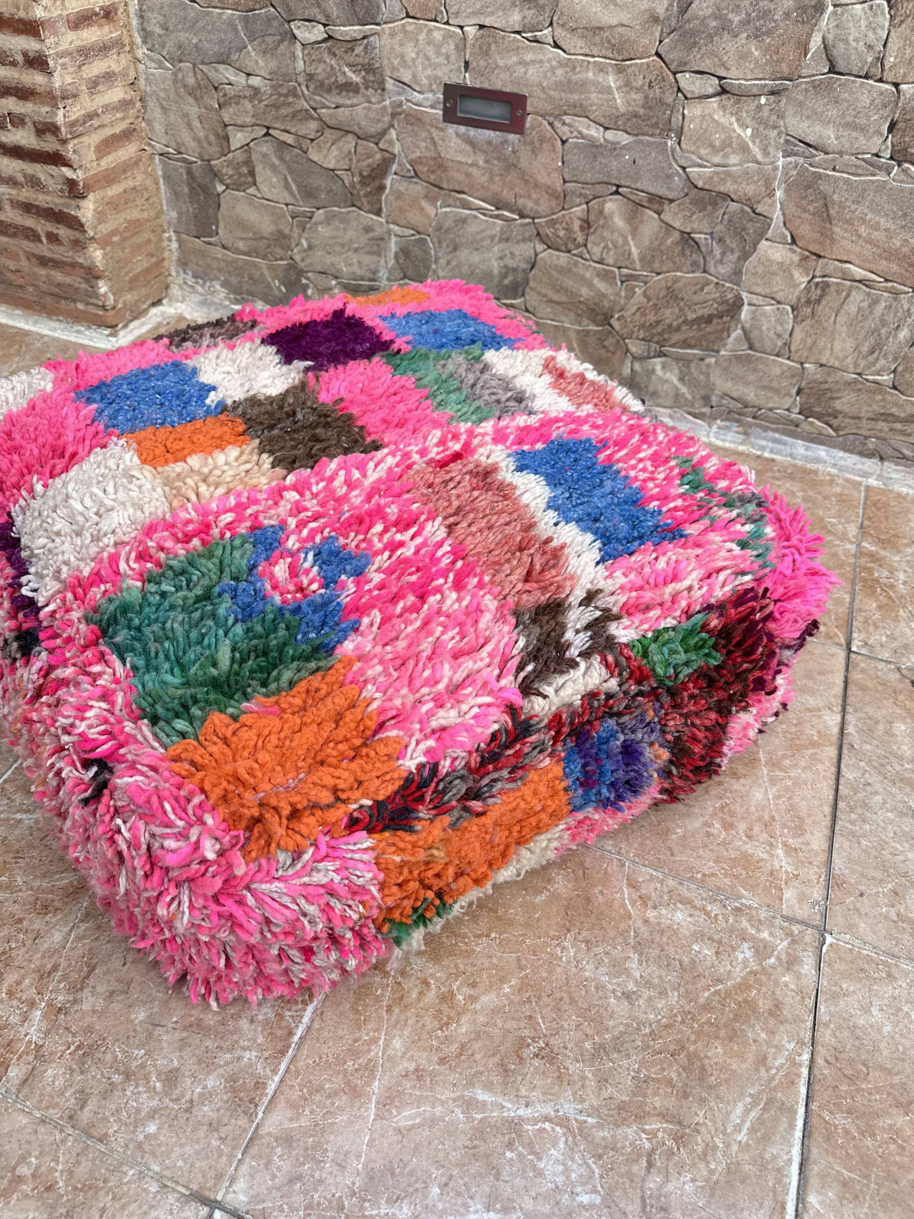 Berber floor pouf: Handwoven Moroccan wool cushion.