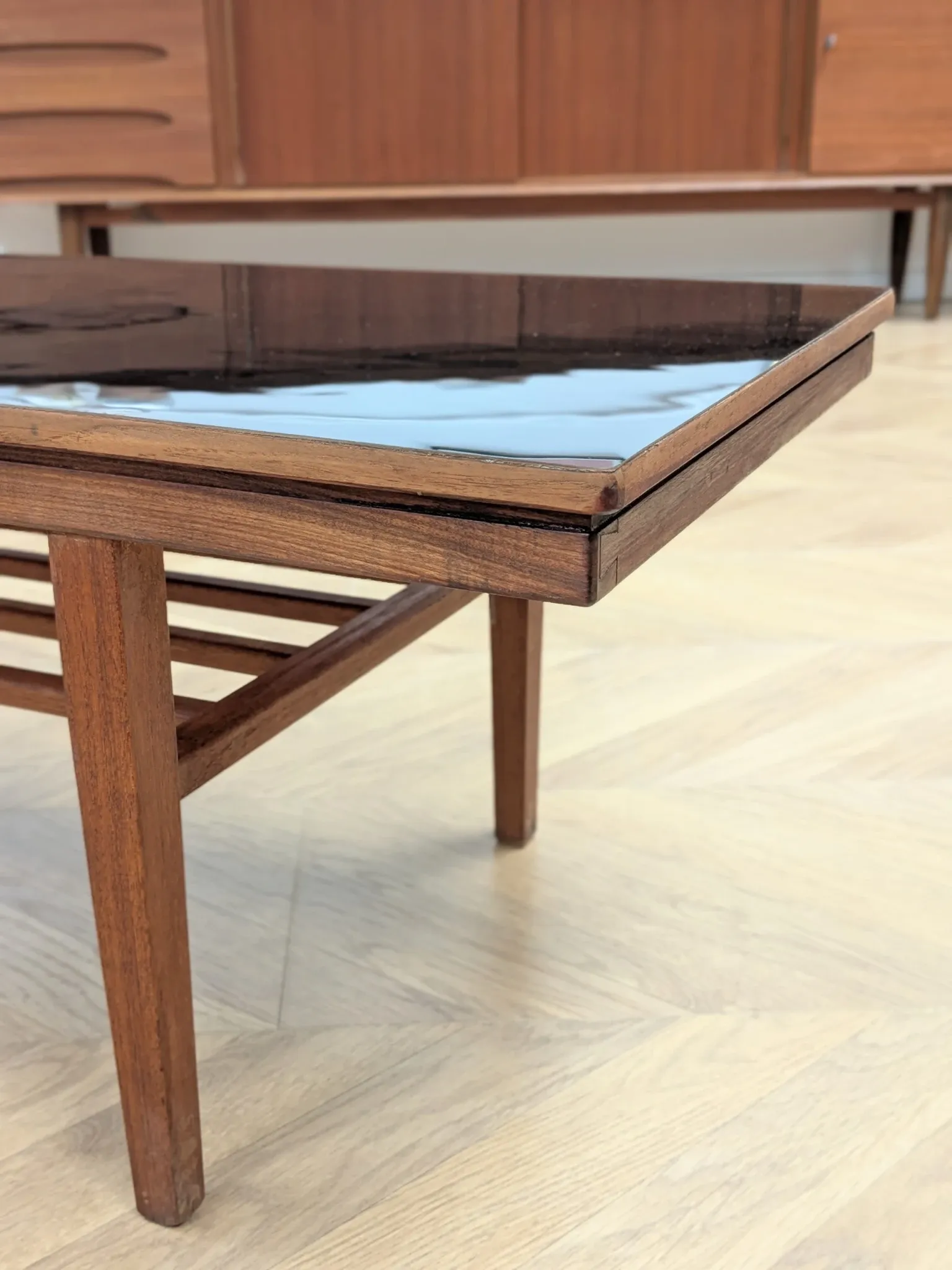 Vintage Danish coffee table in teak with a black top from the 1960s.
