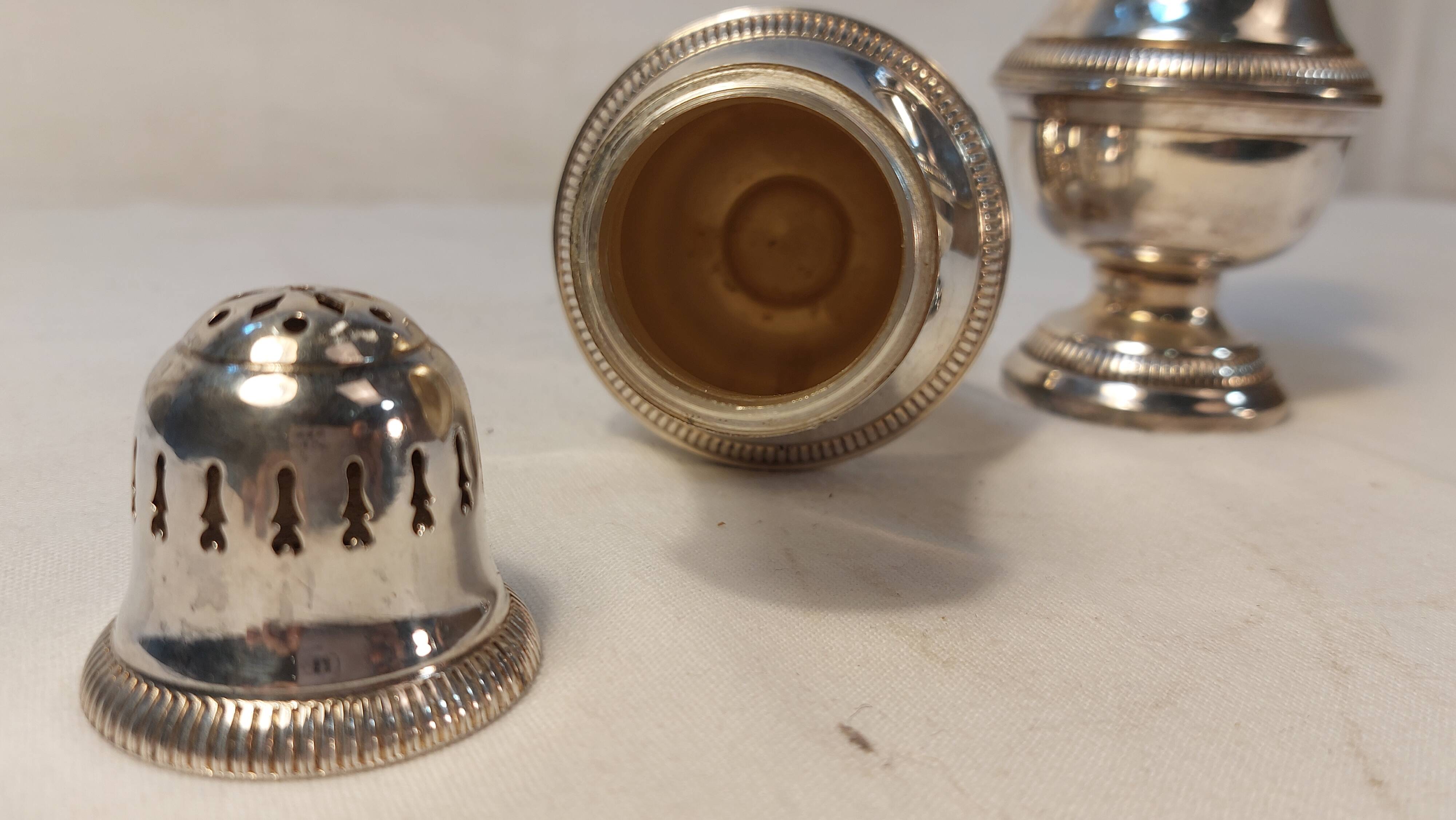 Set of two silver metal sprinklers