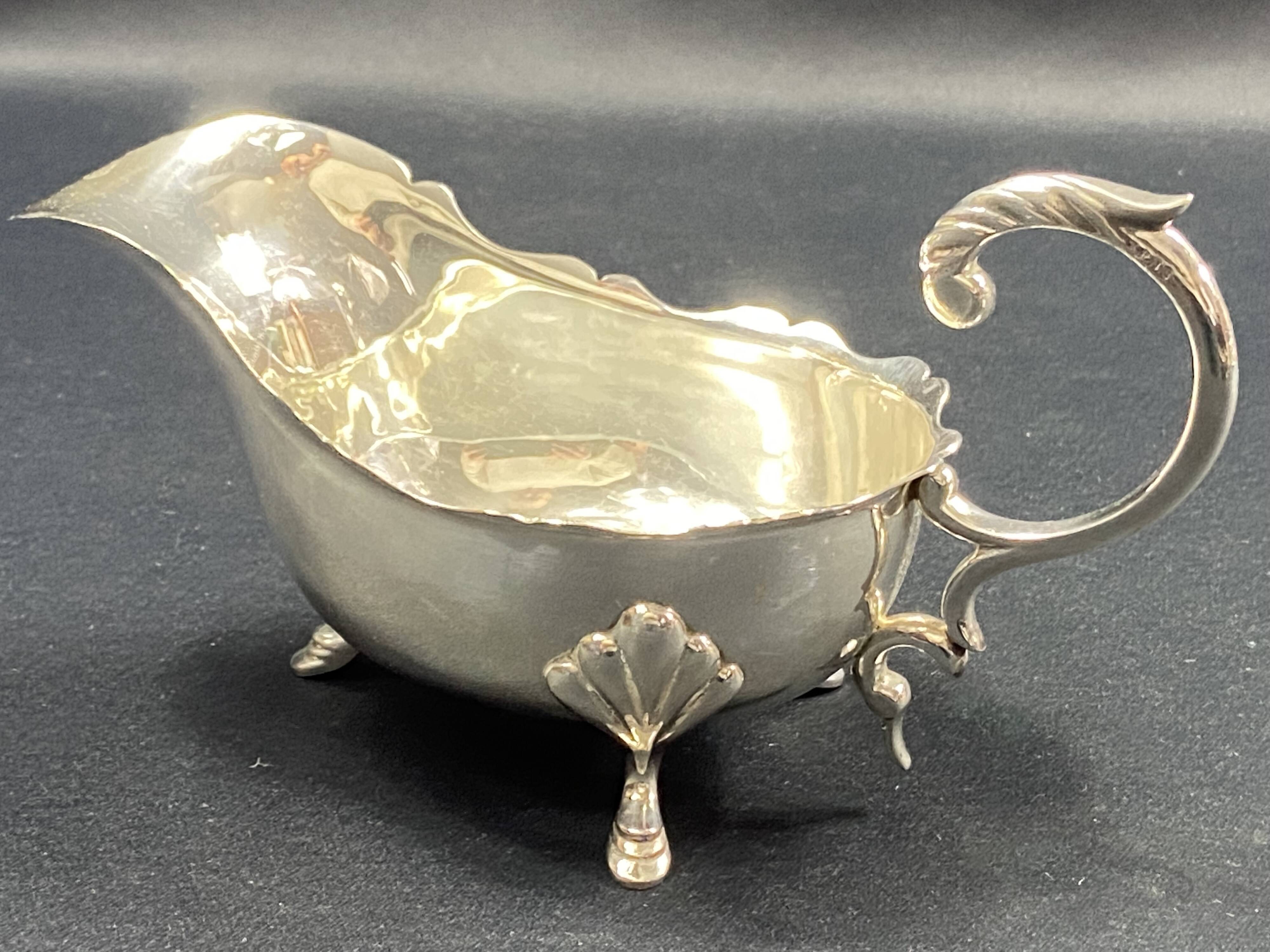 English George III style silver plated tripod sauce boat