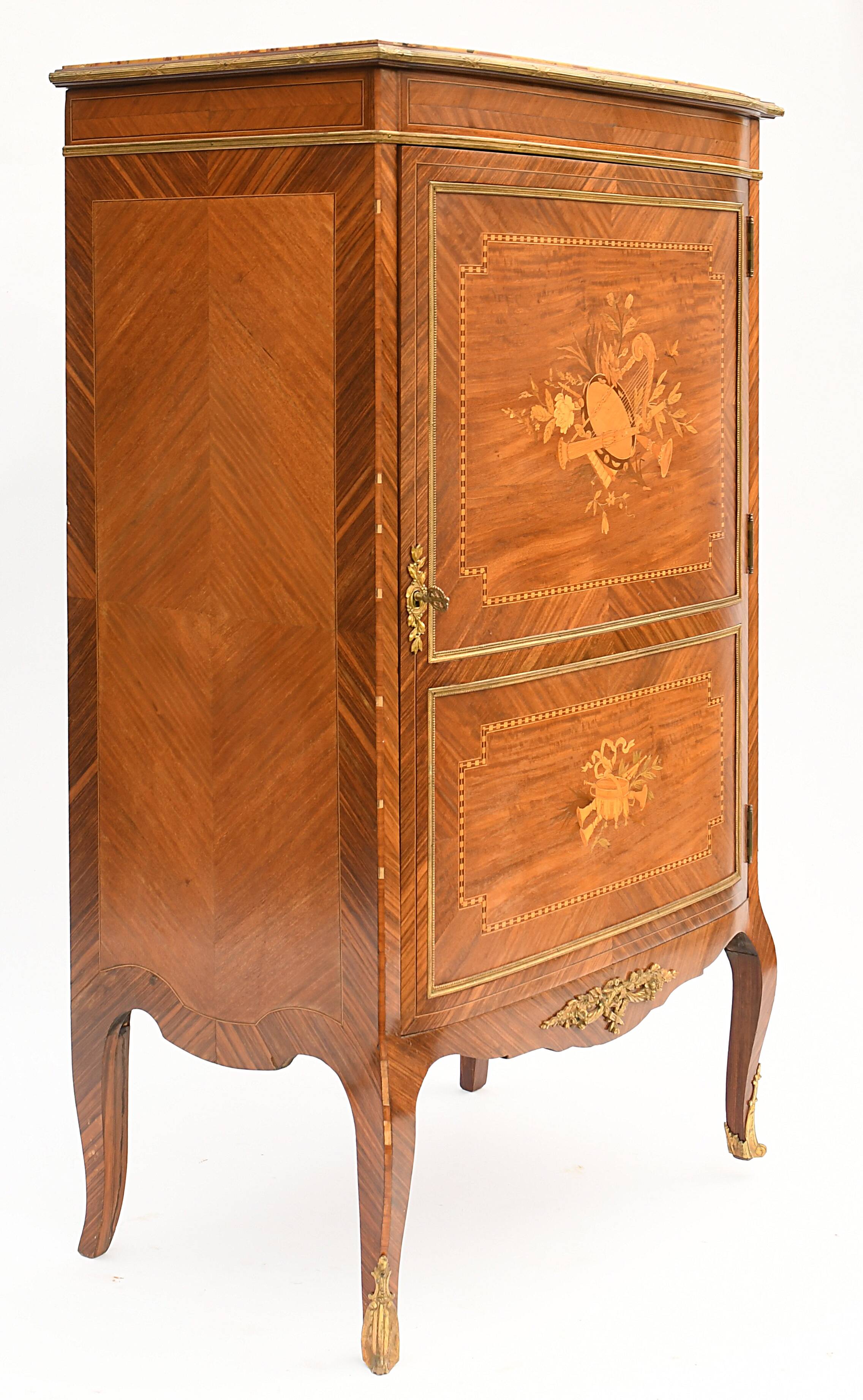 In-between furniture in marquetry decorated with a trophy decoration of musical instruments