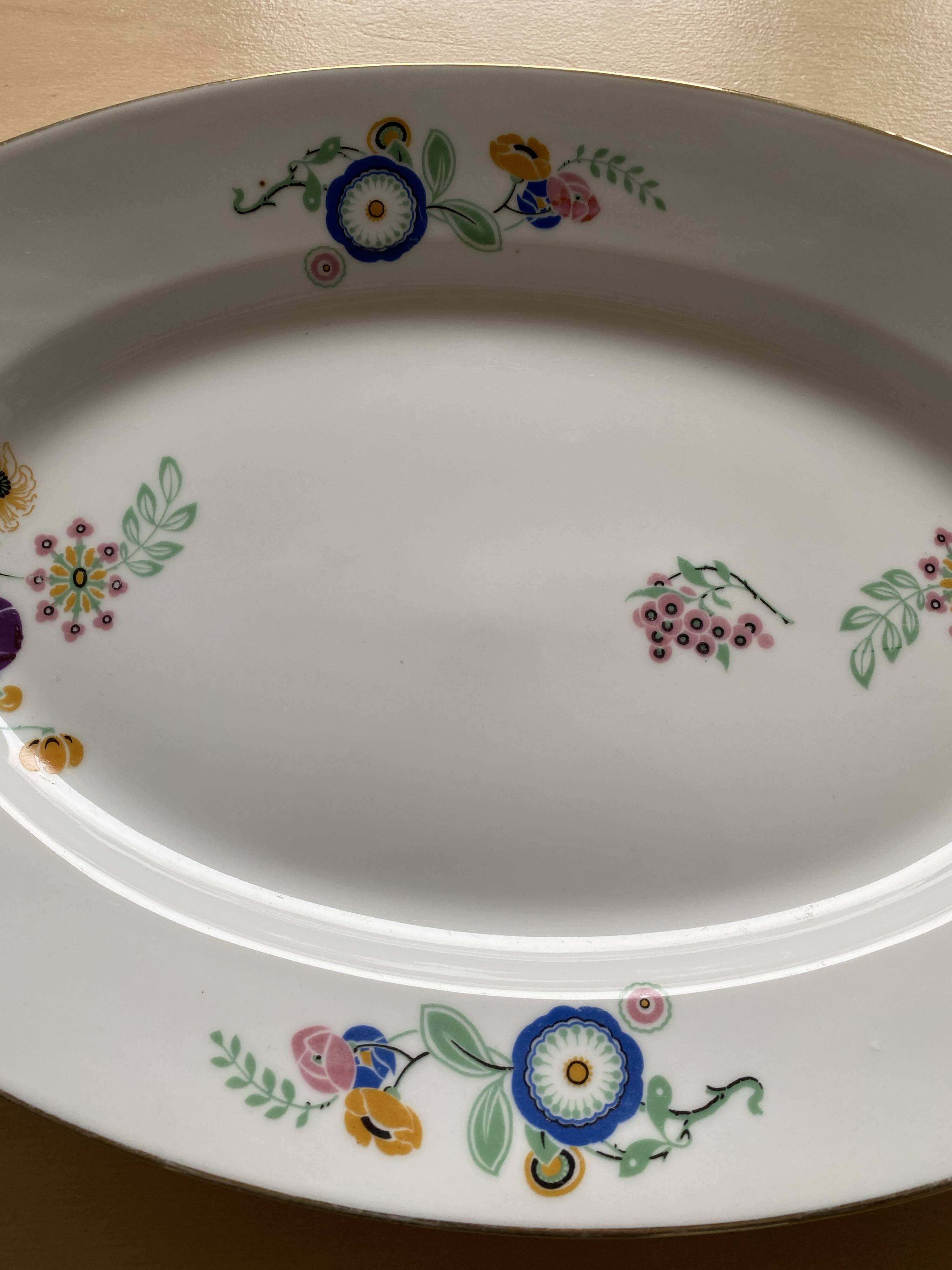 Oval vintage plate in white Limoges porcelain signed T.L.B flowers.