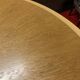 Round wooden and metal quadripod dining table
