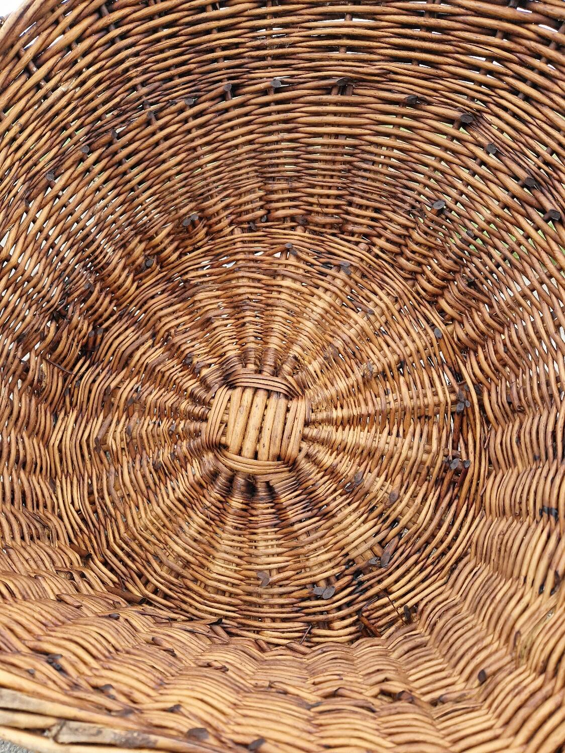 Old throne basket armchair in woven wicker