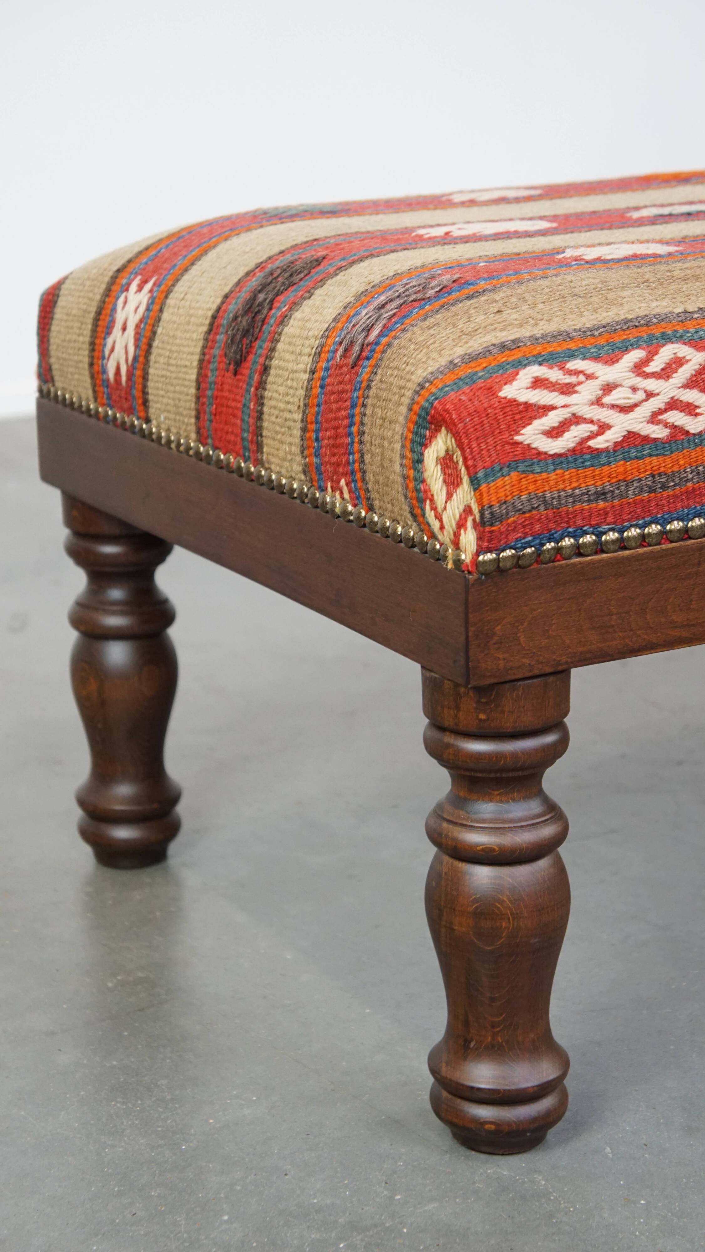 Oriental pouf upholstered in an antique kilim