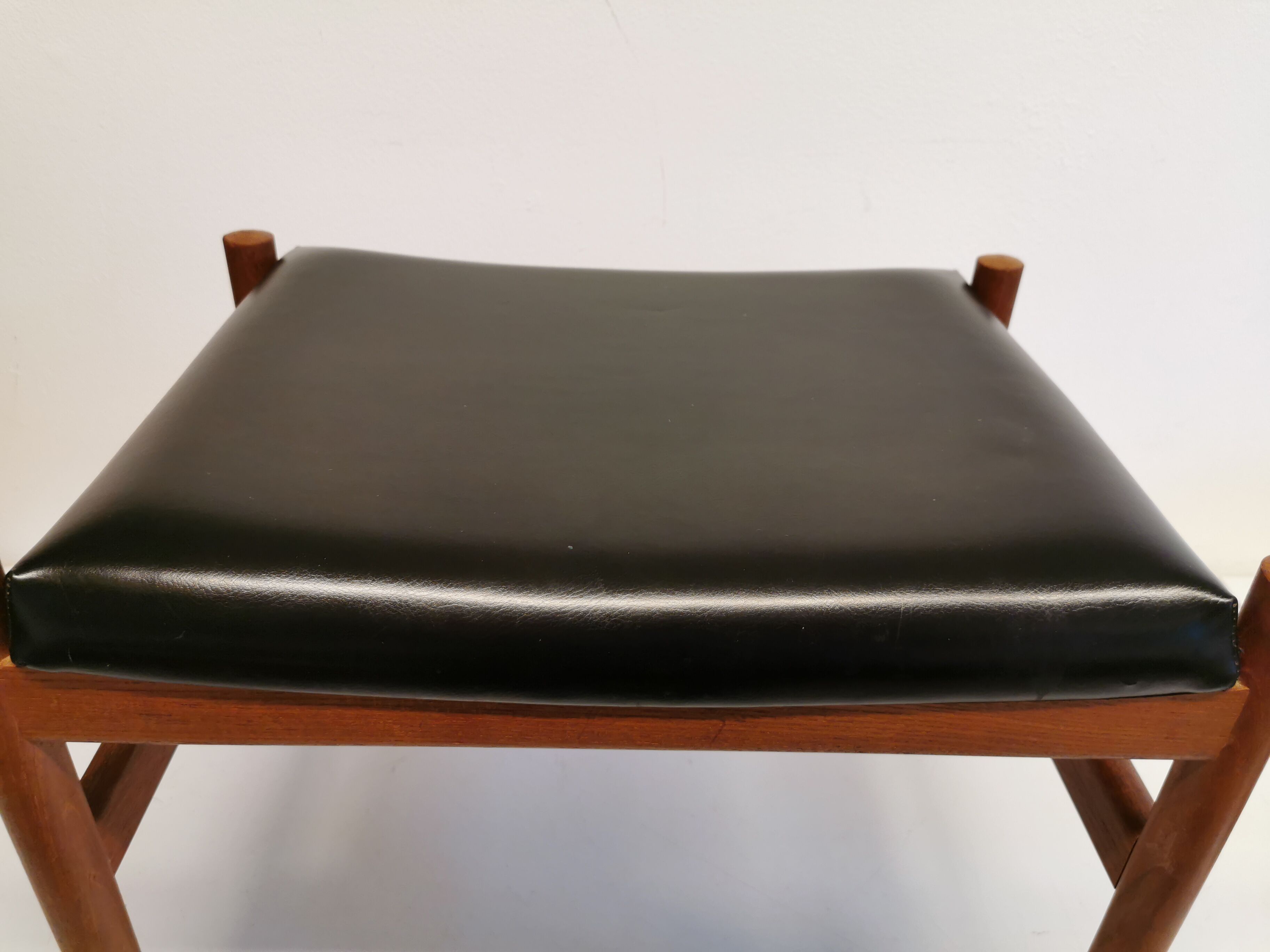 Danish designed footstool, in teak and black skai. Made at Spøttrup furniture factory in the 1960s.