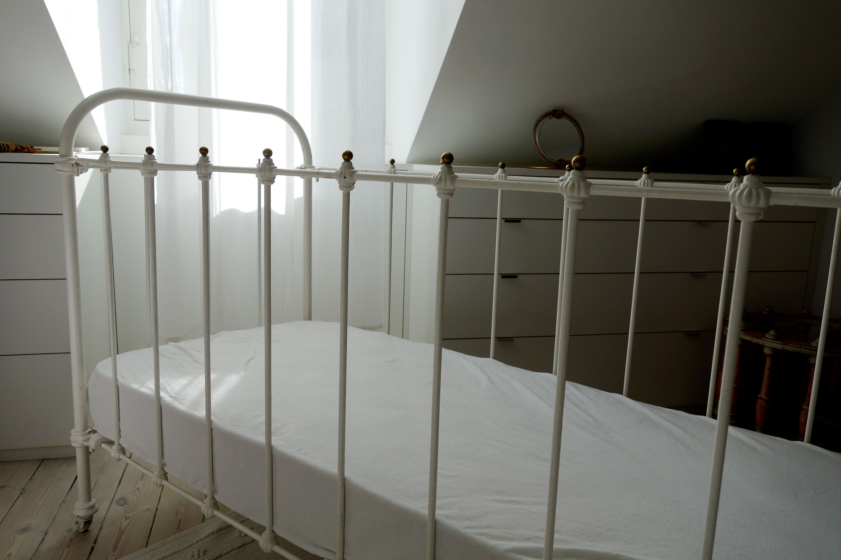 Old bed in wrought iron and brass balls