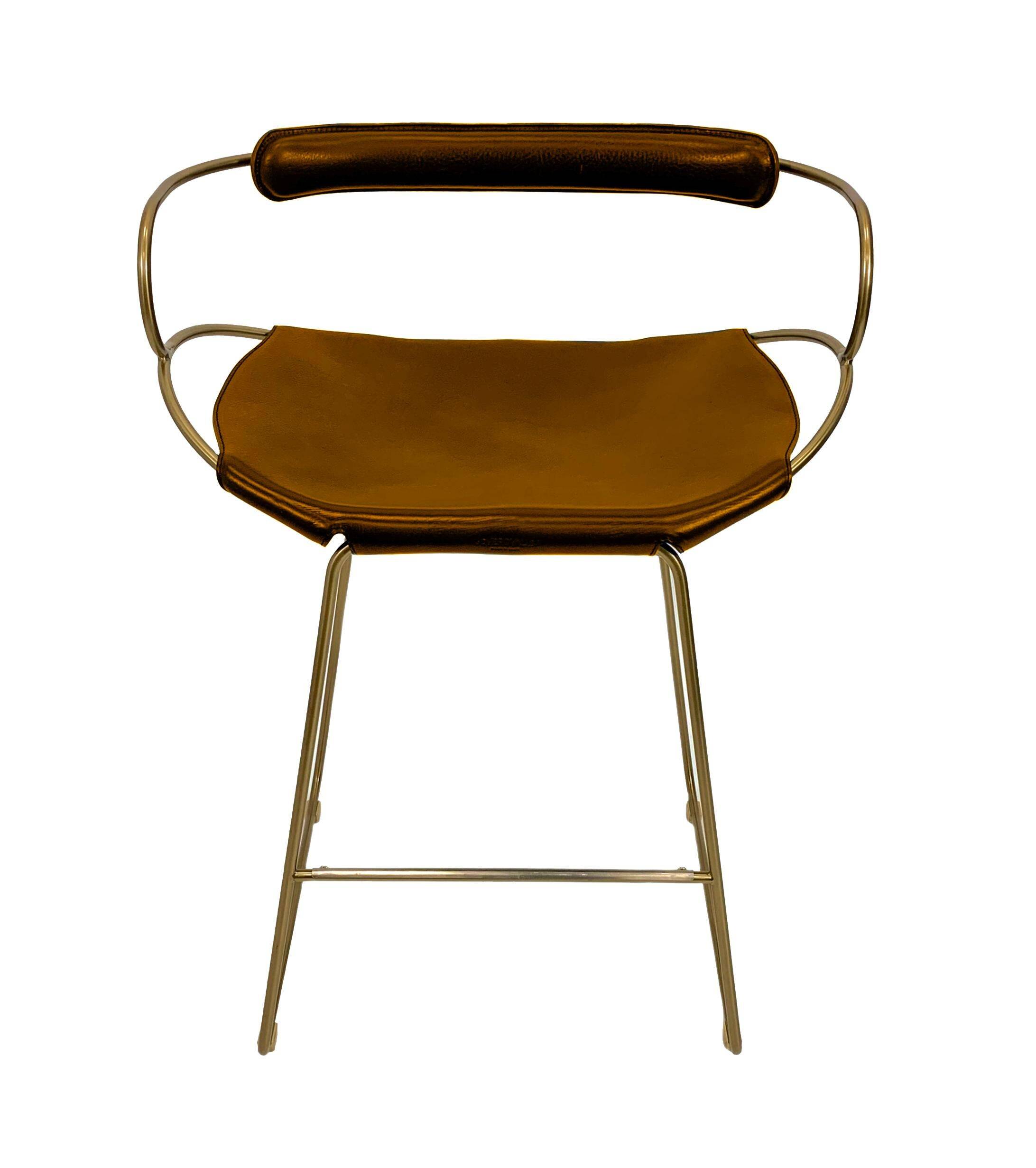 Contemporary bar stool with a back, aged brass metal and natural tobacco leather.