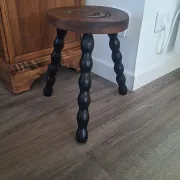 Brown and black wooden tripod stool