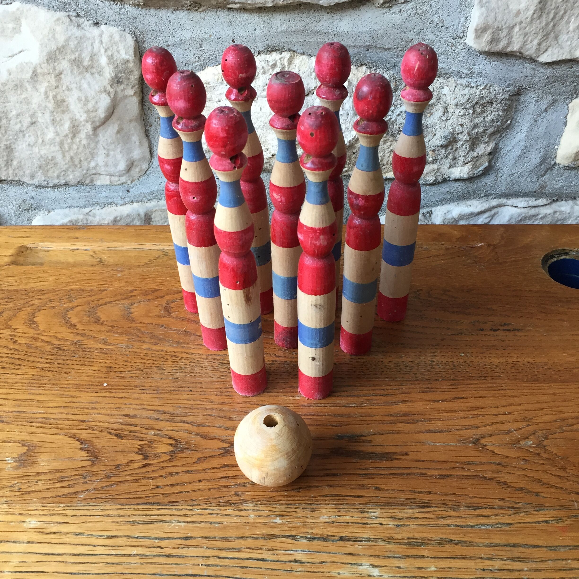 Former wooden tricolor bowling game with its ball