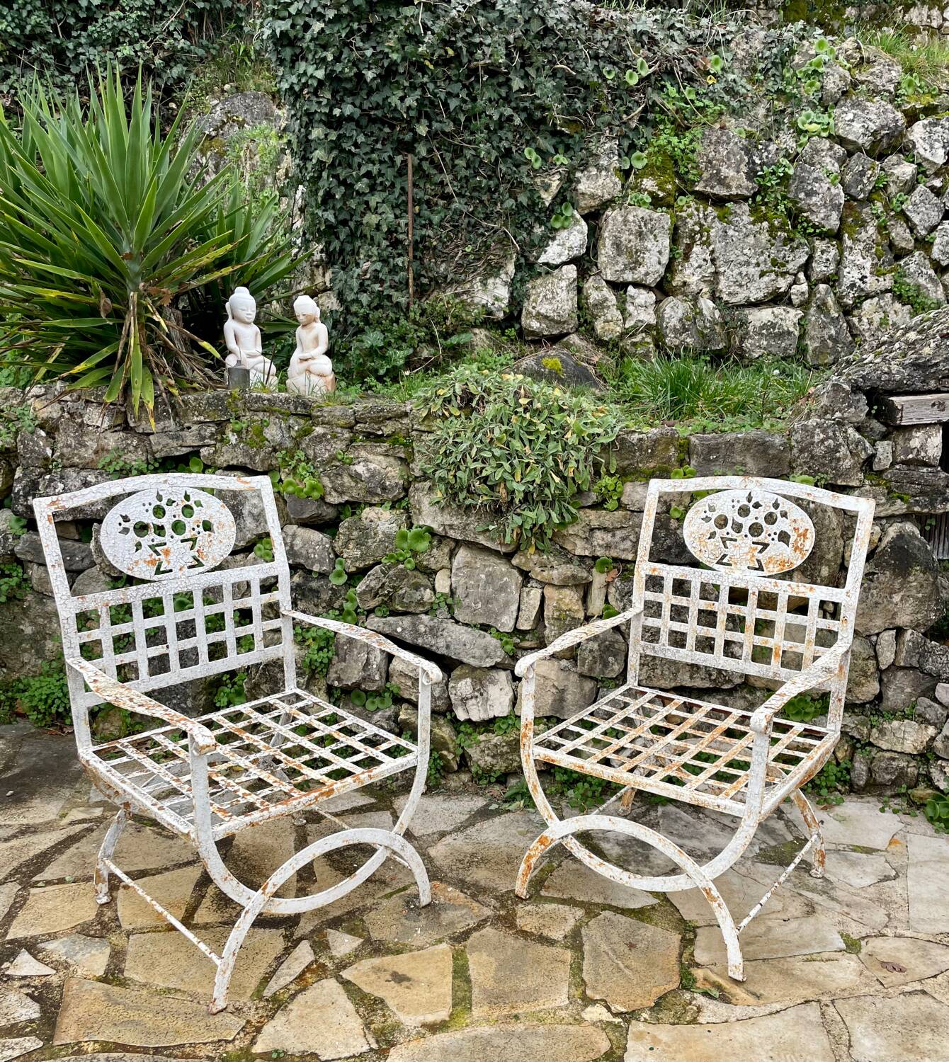 Pair of wrought iron armchairs