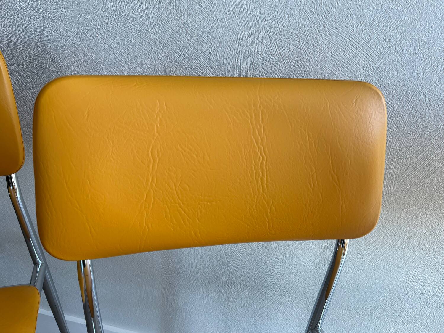 LM vintage chrome and orange/mustard yellow faux leather chairs