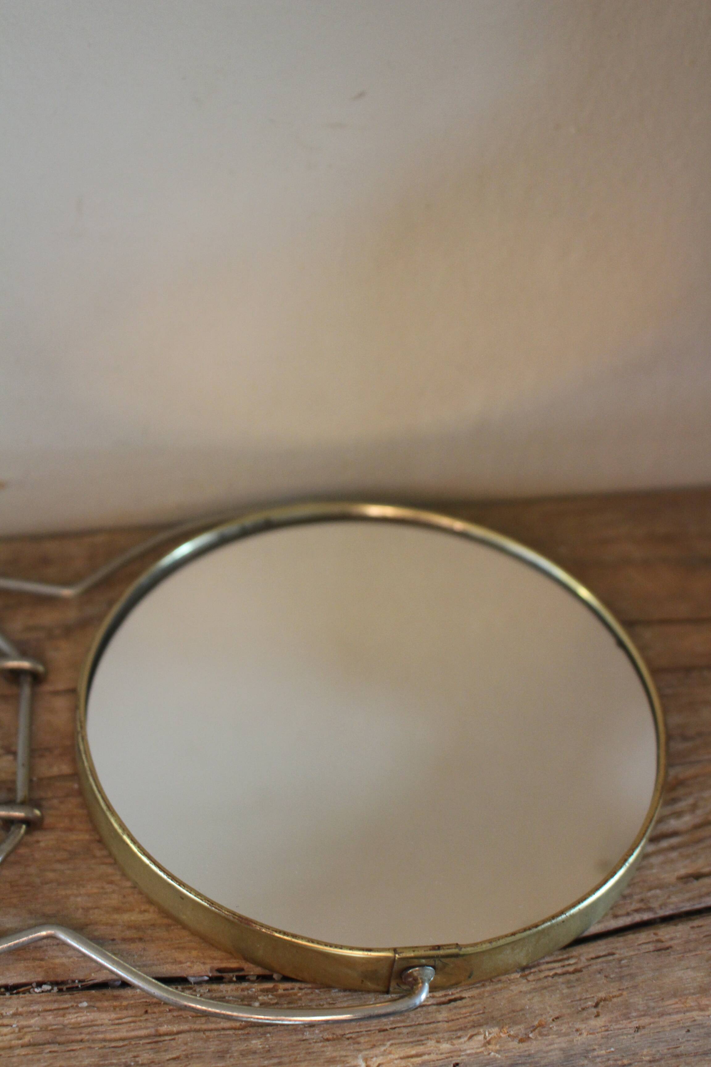 Antique round barber mirror in gilded metal