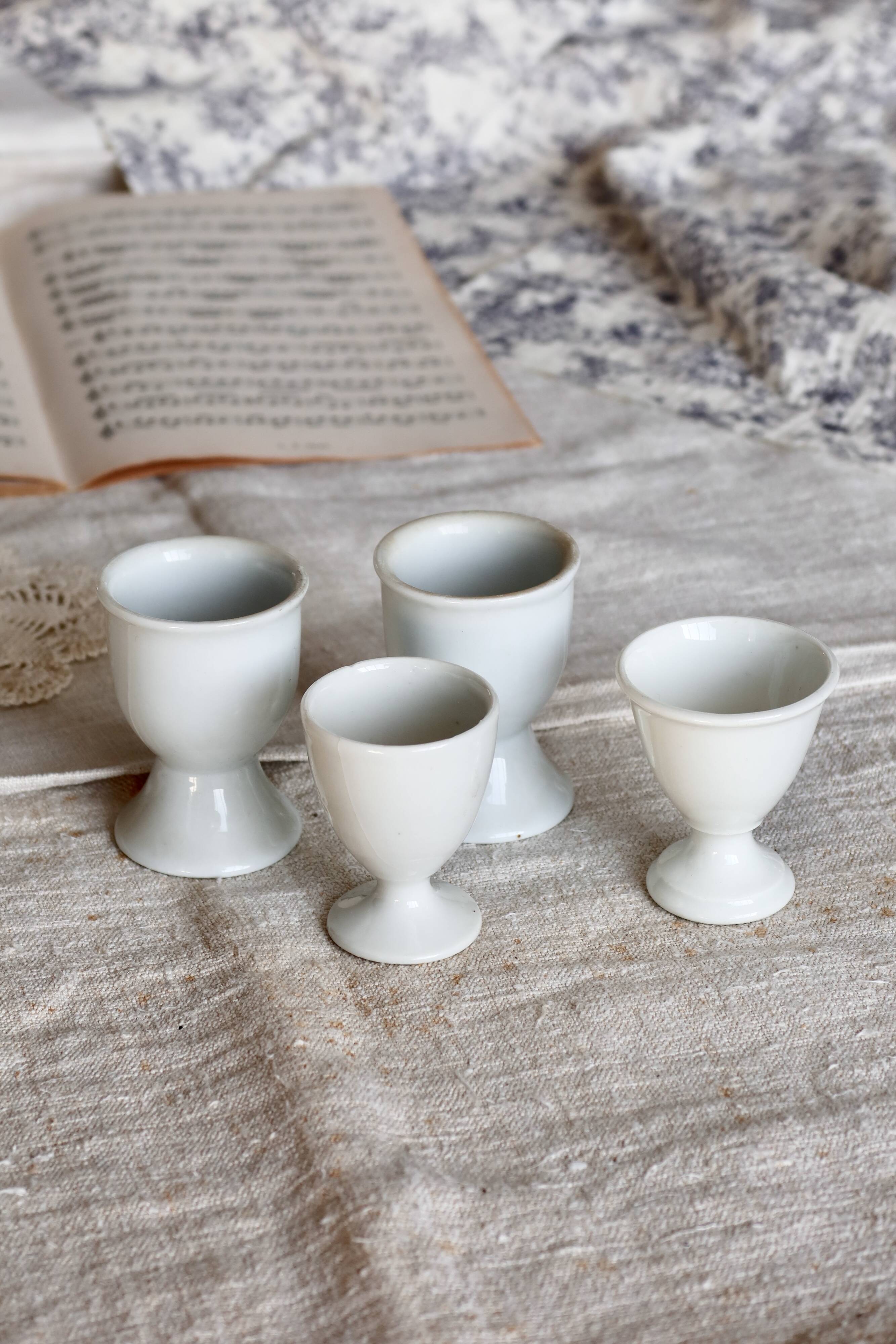 4 mismatched vintage white porcelain egg cups