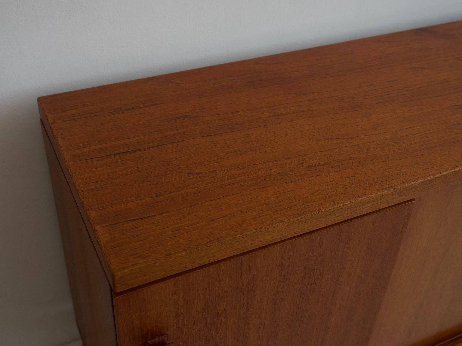 Modern mid-century teak sideboard with brass details.