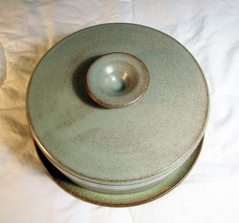 Sandstone cheese platter and bell