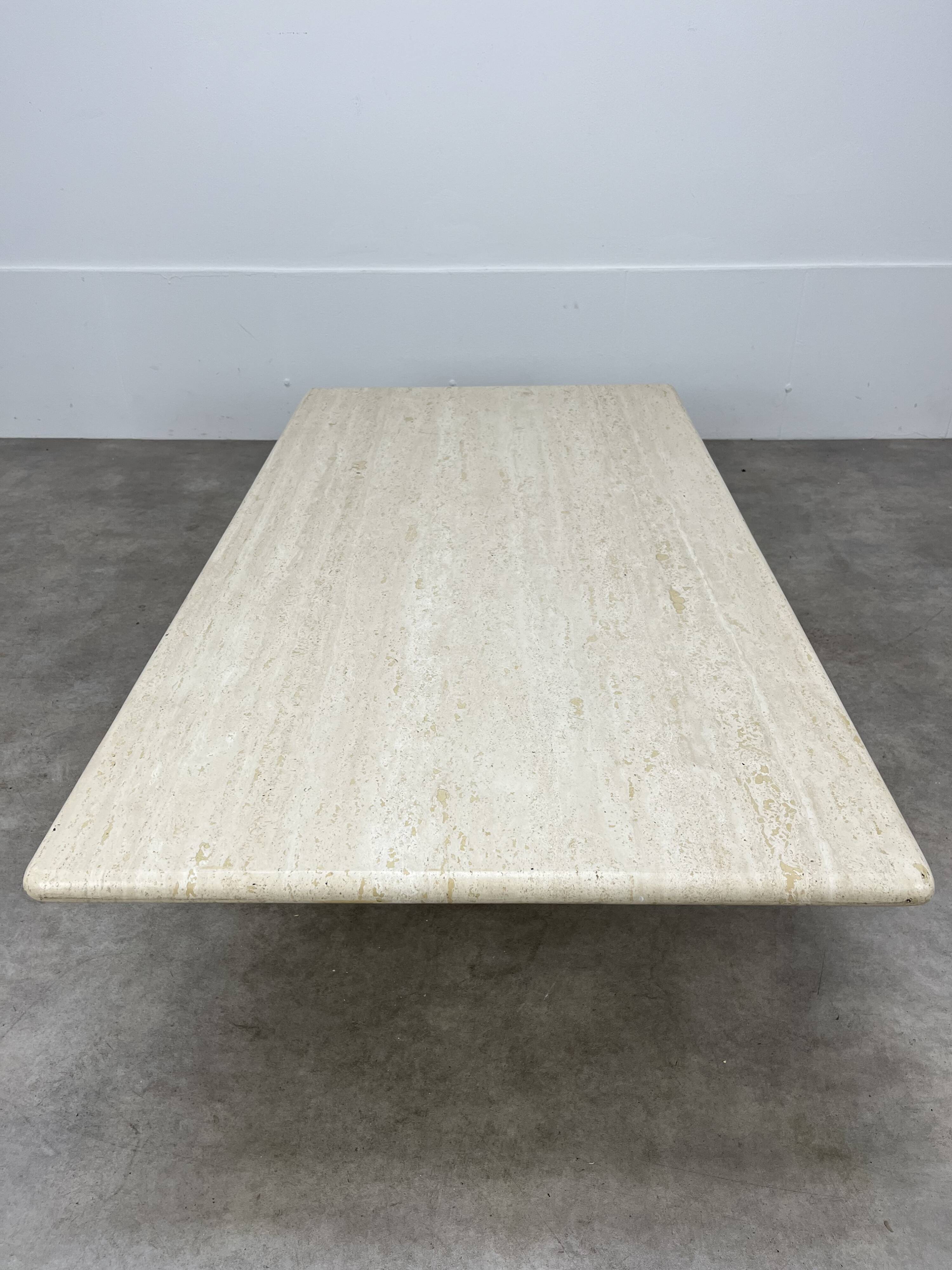 Rectangular travertine coffee table with central leg