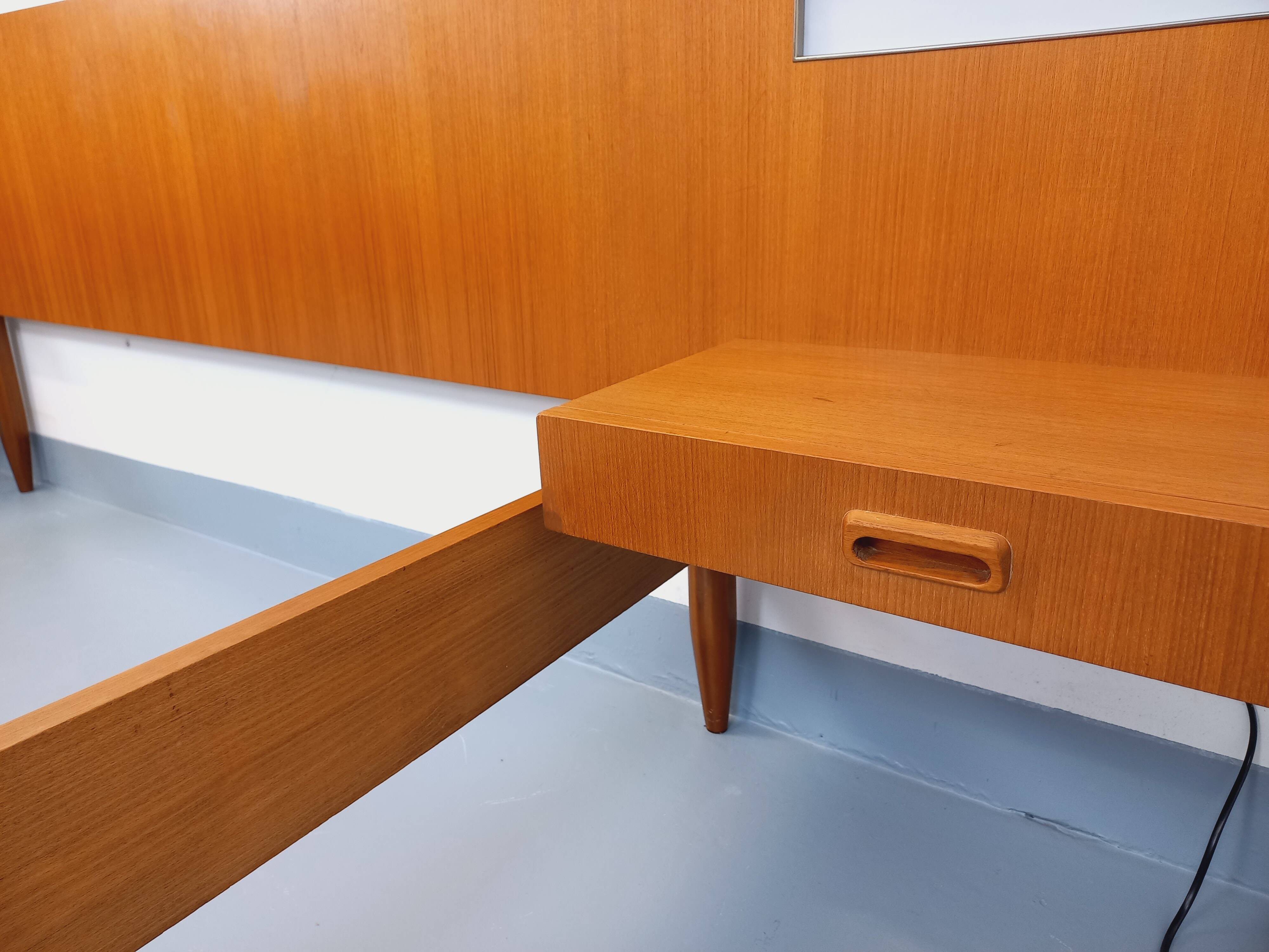Double bed in vintage Scandinavian style from the 1960s with bedside tables.