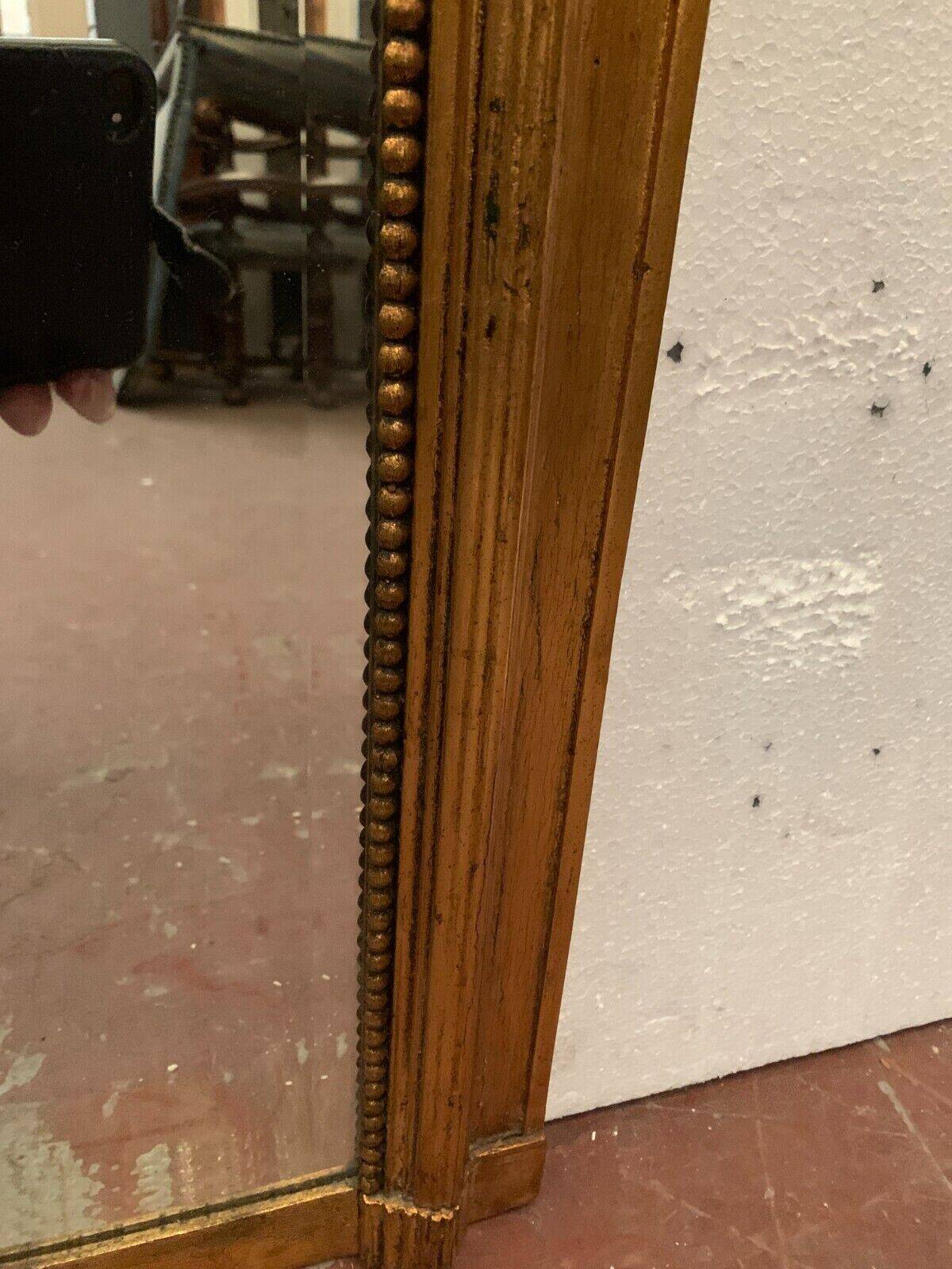 Louis XVI style mirror in wood and gilded stucco 20th century