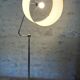 Flexible floor lamp, chrome, opaque white shade with metallic edges.